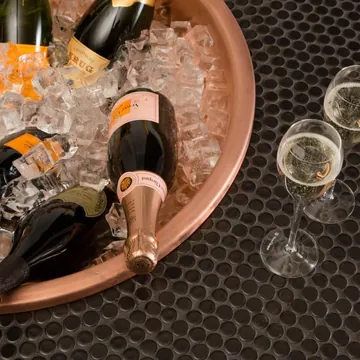 Champagne on ice in a copper tray