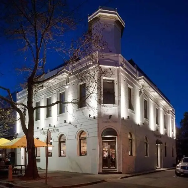 The Coppersmith Hotel glowing at dusk on the corner of Clarendon Street